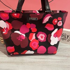 Slightly used kate spade purse. Black Pink and red floral print.